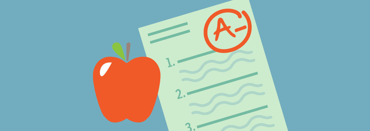 A school assignment with an A- grade on it alongside an apple